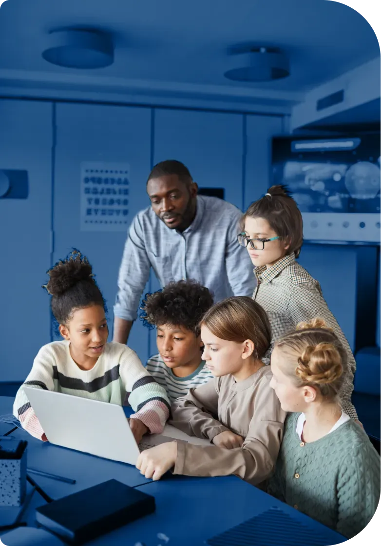 a group of kids and their teacher learning with a notebook